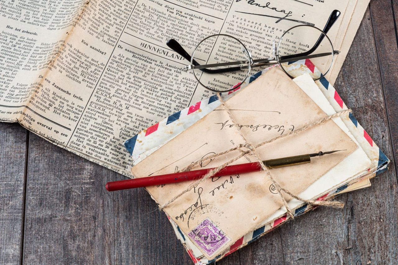Letters and envelopes, collected with a cord, on wood