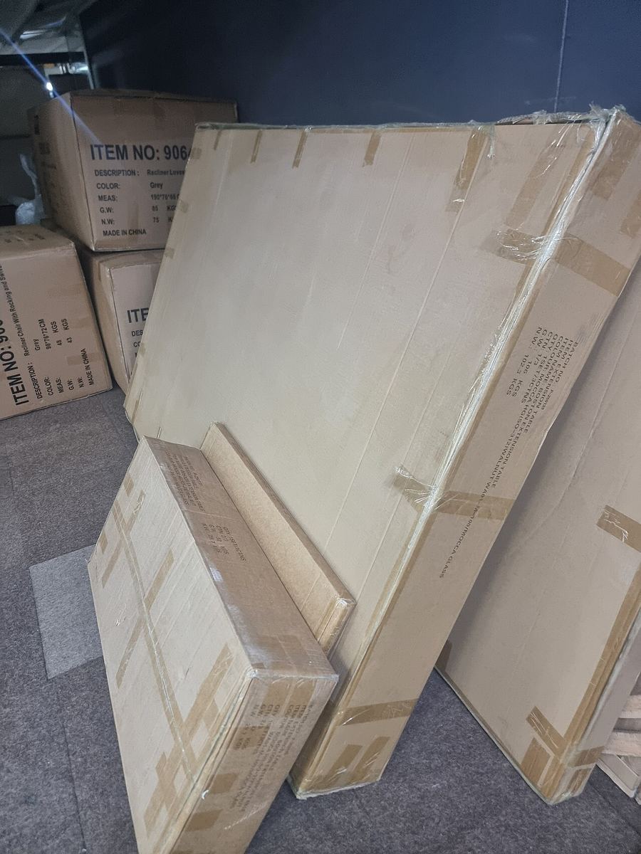 Flat-packed furniture boxes and shipping cartons in a storage room
