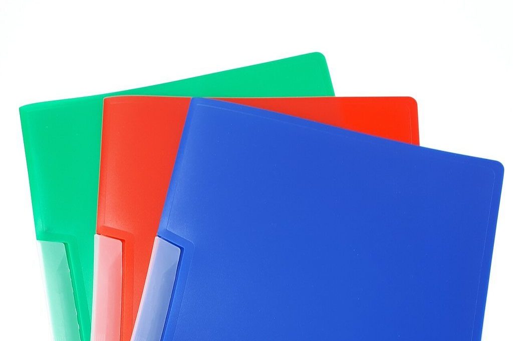 Three coloured clip folders on a white background, symbolising receipt filing