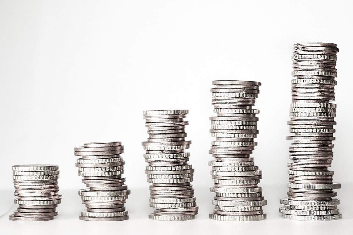 Several coin columns of different heights on a light background